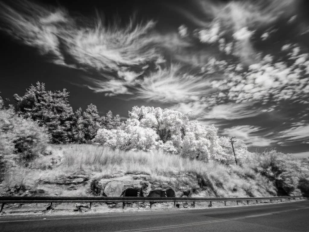Ancient cave Roadside Under Bright Clouds